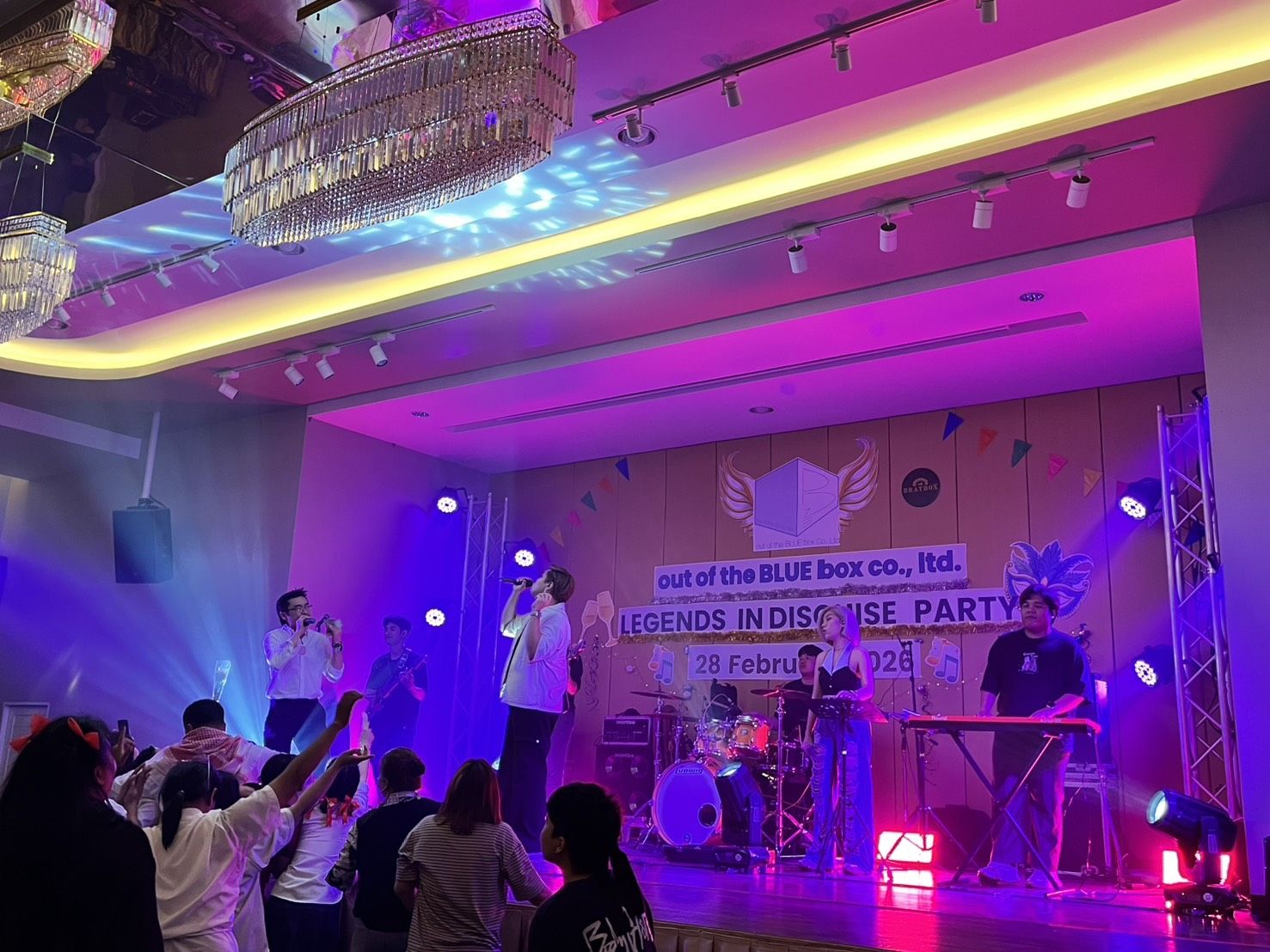 Singer performing to a crowd at a company party