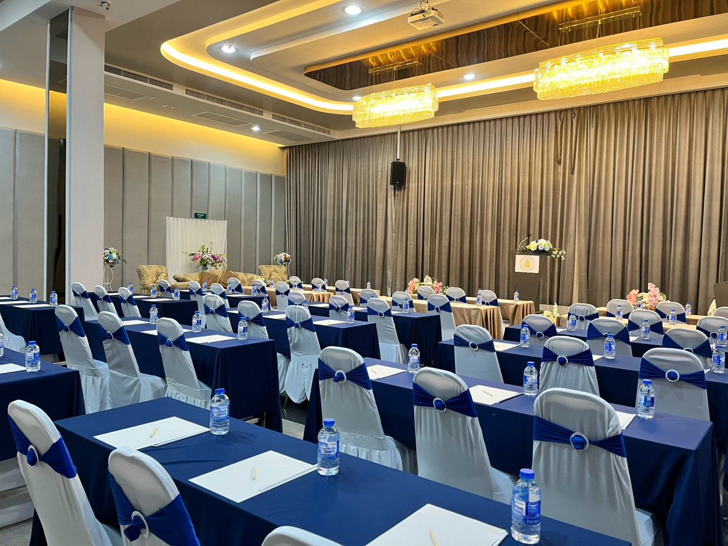 Grand Diamond set classroom-style with navy tables and notepads