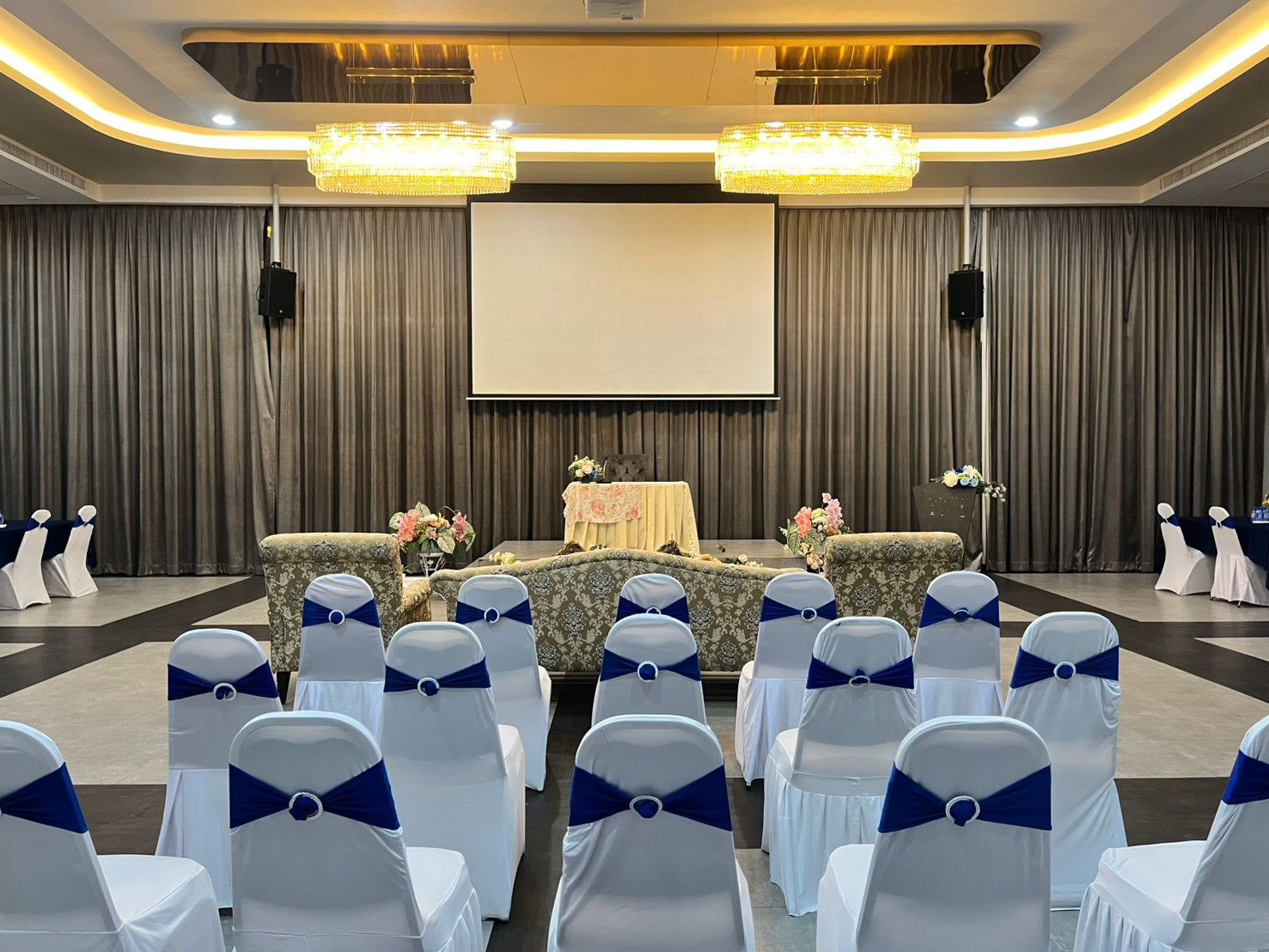 Theatre-style seating facing the projector screen in Grand Diamond