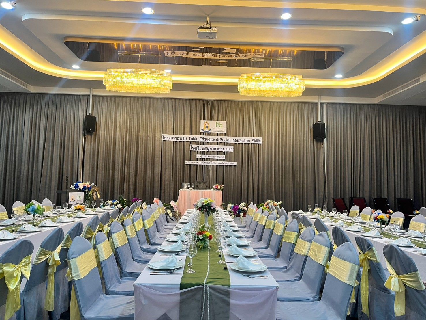 Long dining tables beneath crystal chandeliers in Grand Diamond