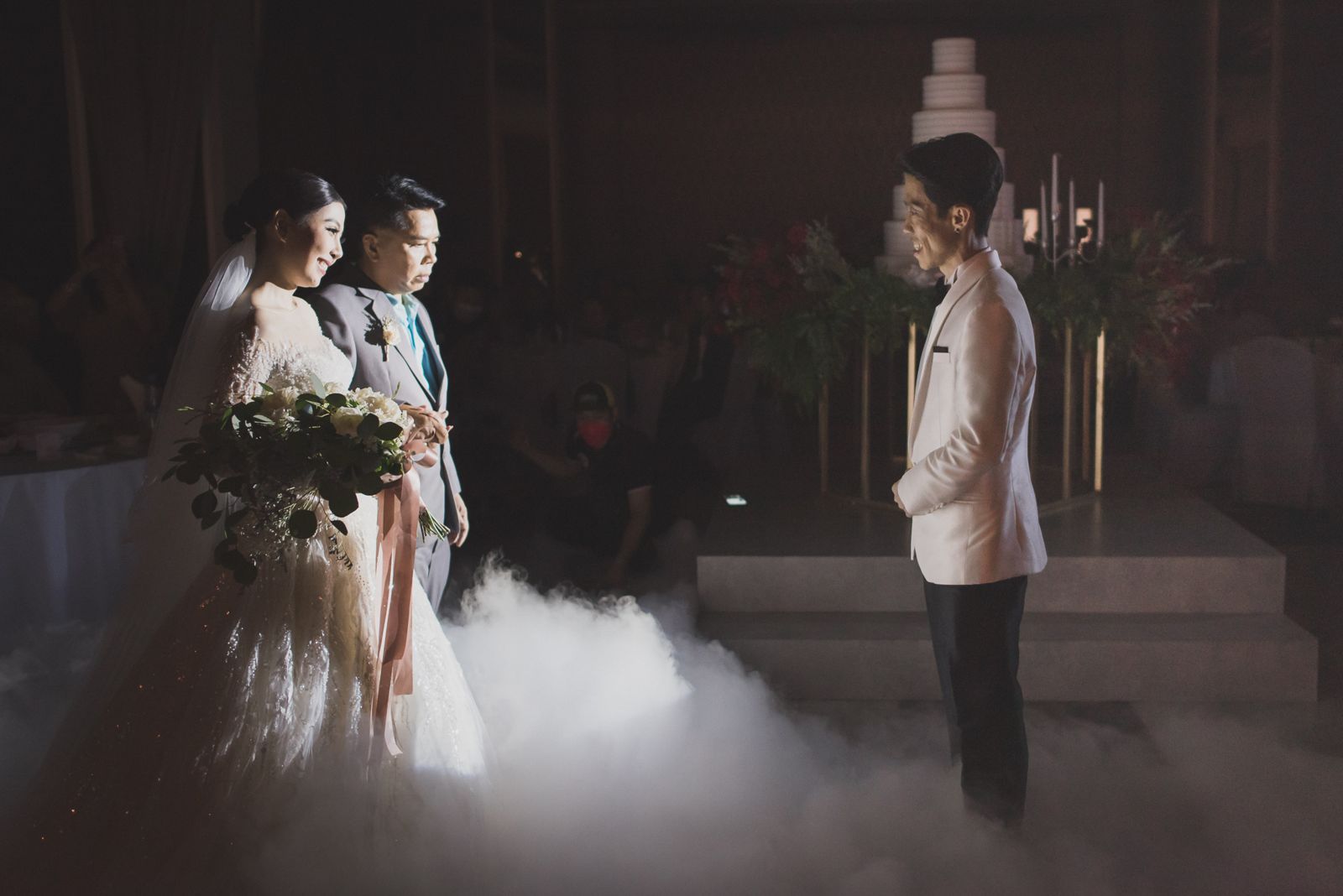 Bride walking in with her father through stage fog