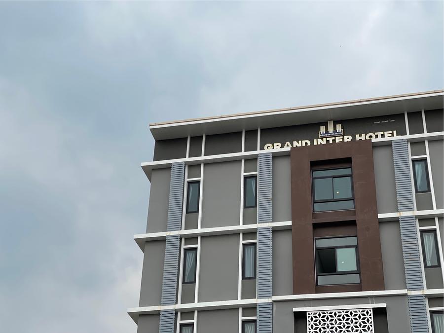 Hotel facade with the Grand Inter Hotel sign against the sky