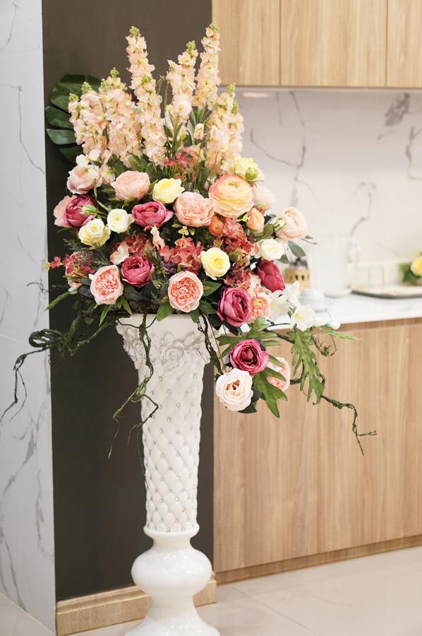 Floral arrangement in a tall white vase
