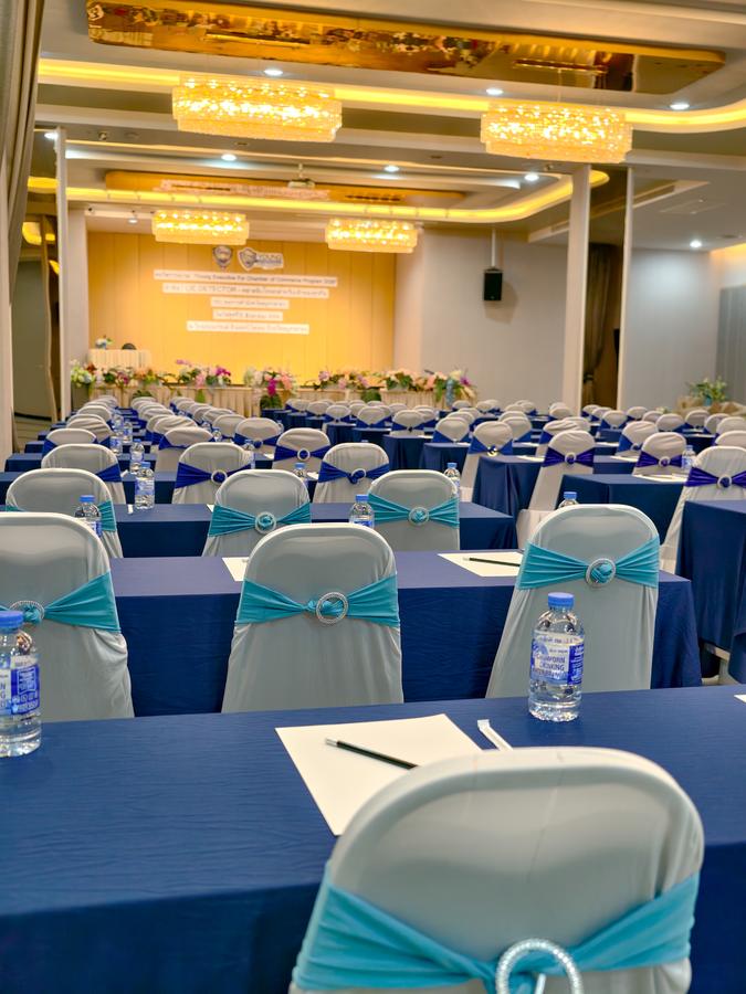 Seminar table laid with notepad, pen and drinking water