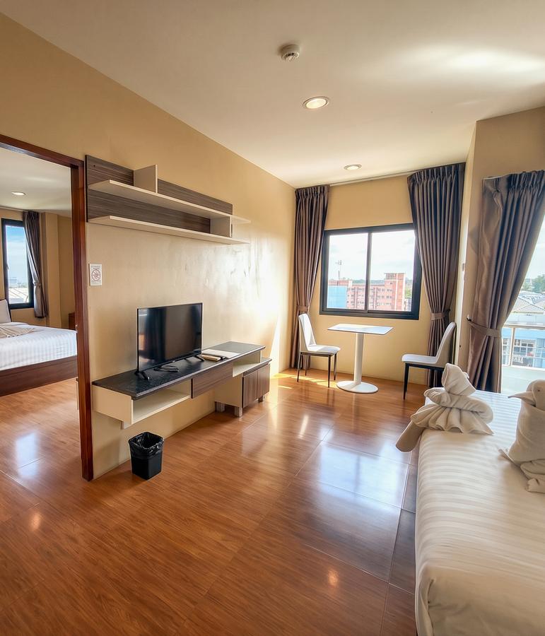 Suite living area with a TV, dining table and separate bedroom