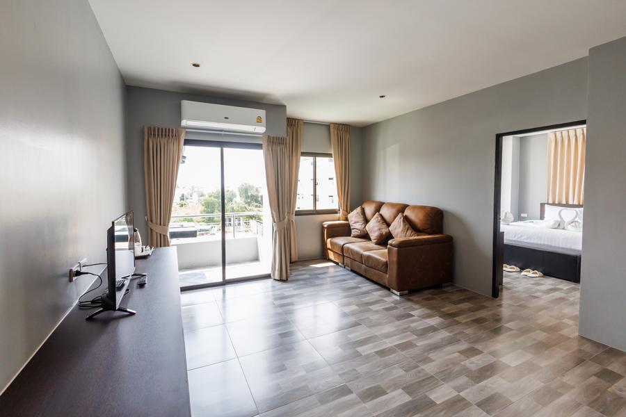 VIP Suite living room with sofa and a view into the bedroom