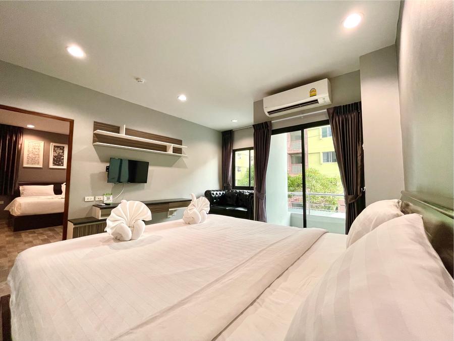 Bed with towel swans and a living area with sofa