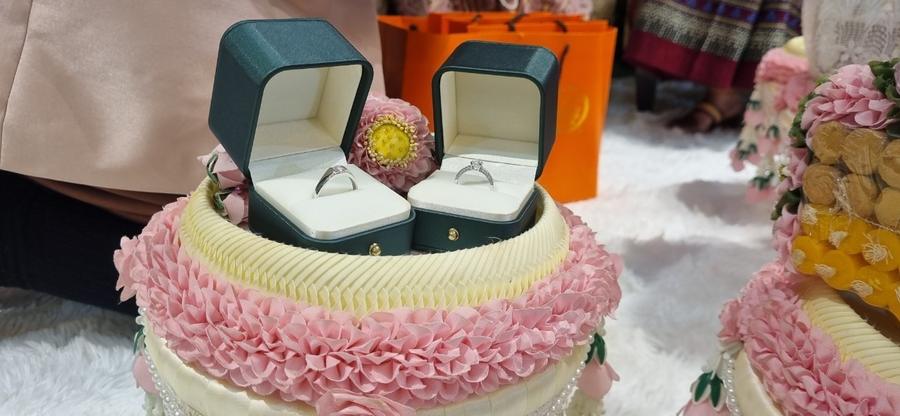 Wedding rings presented on a traditional Thai offering tray