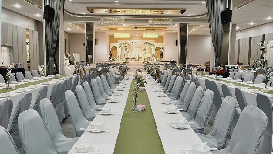 Banquet hall set with long tables for a wedding reception