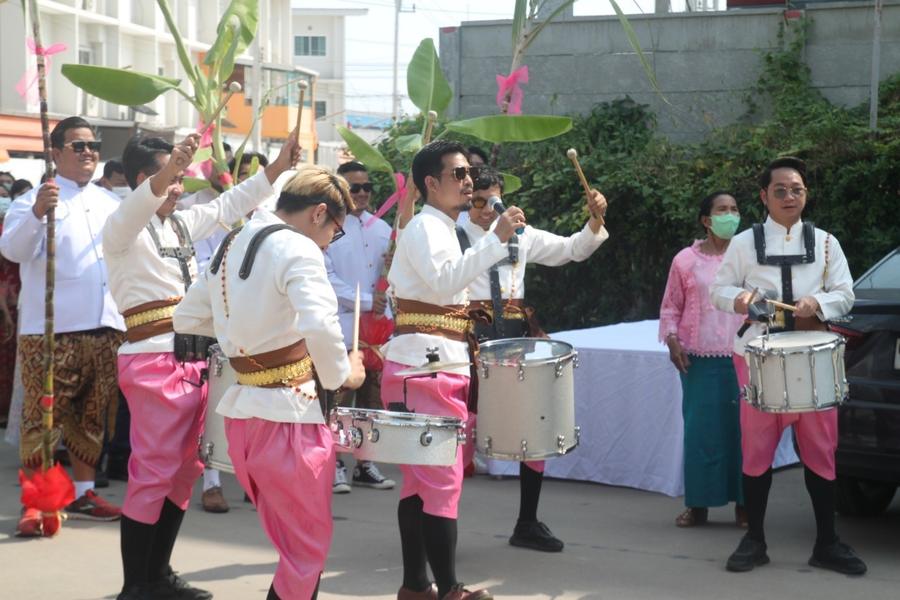 Drummers in pink and white dancing in the procession