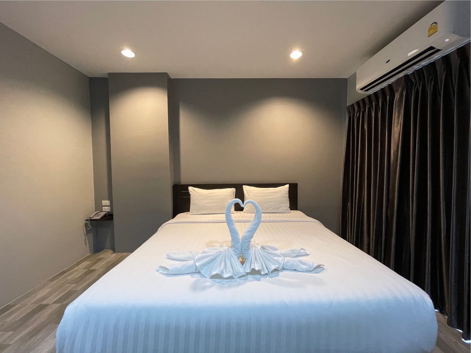 Double bed decorated with towel swans
