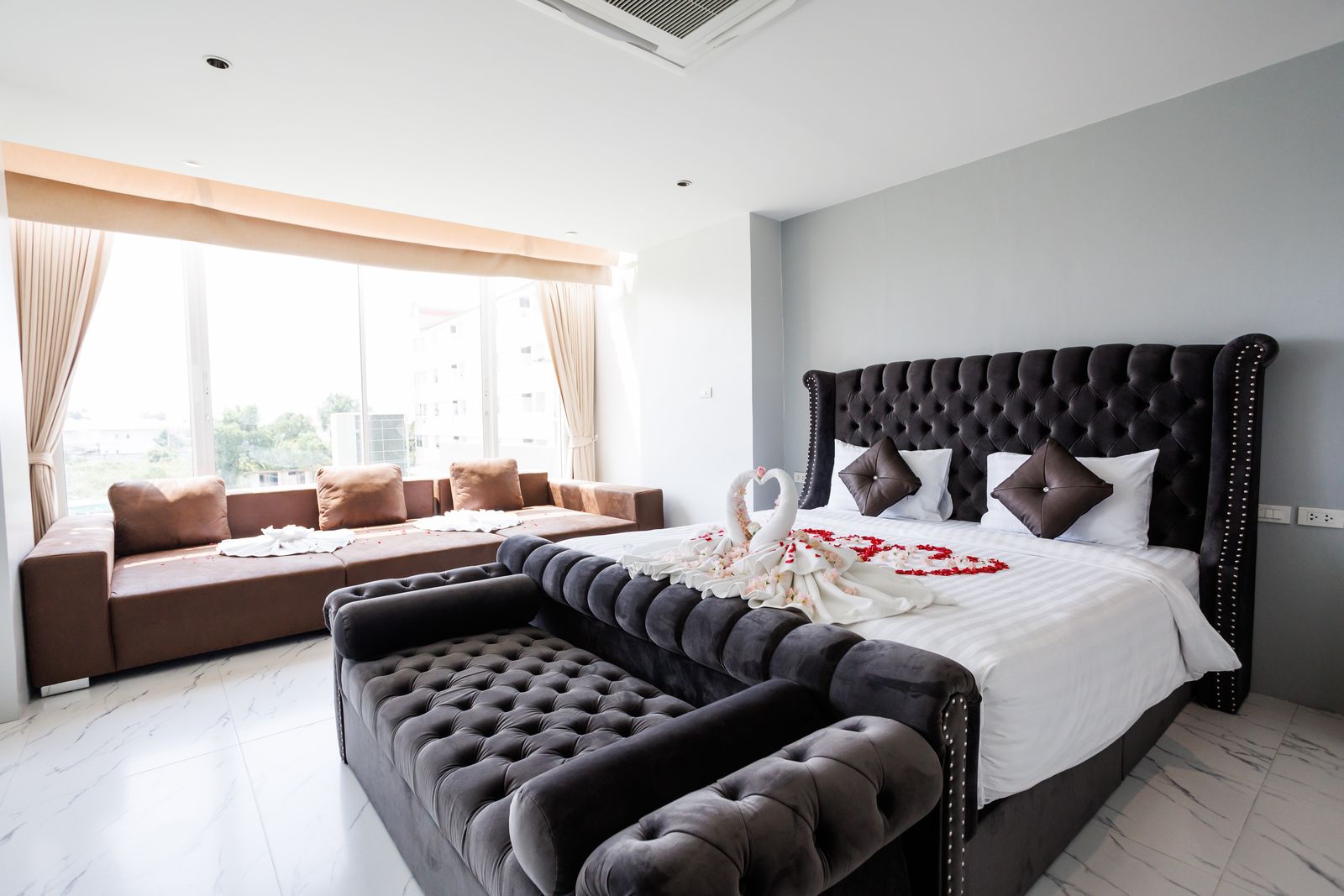 Bed and lounge sofas beside the window