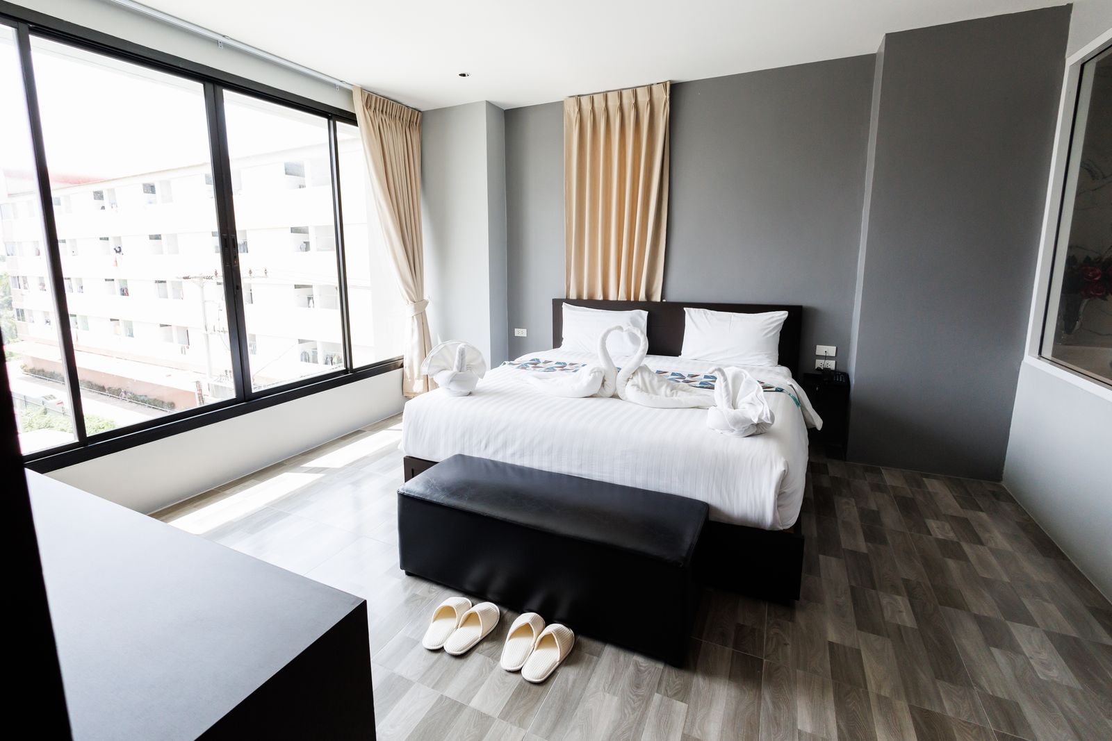 VIP suite bedroom with large windows and bench