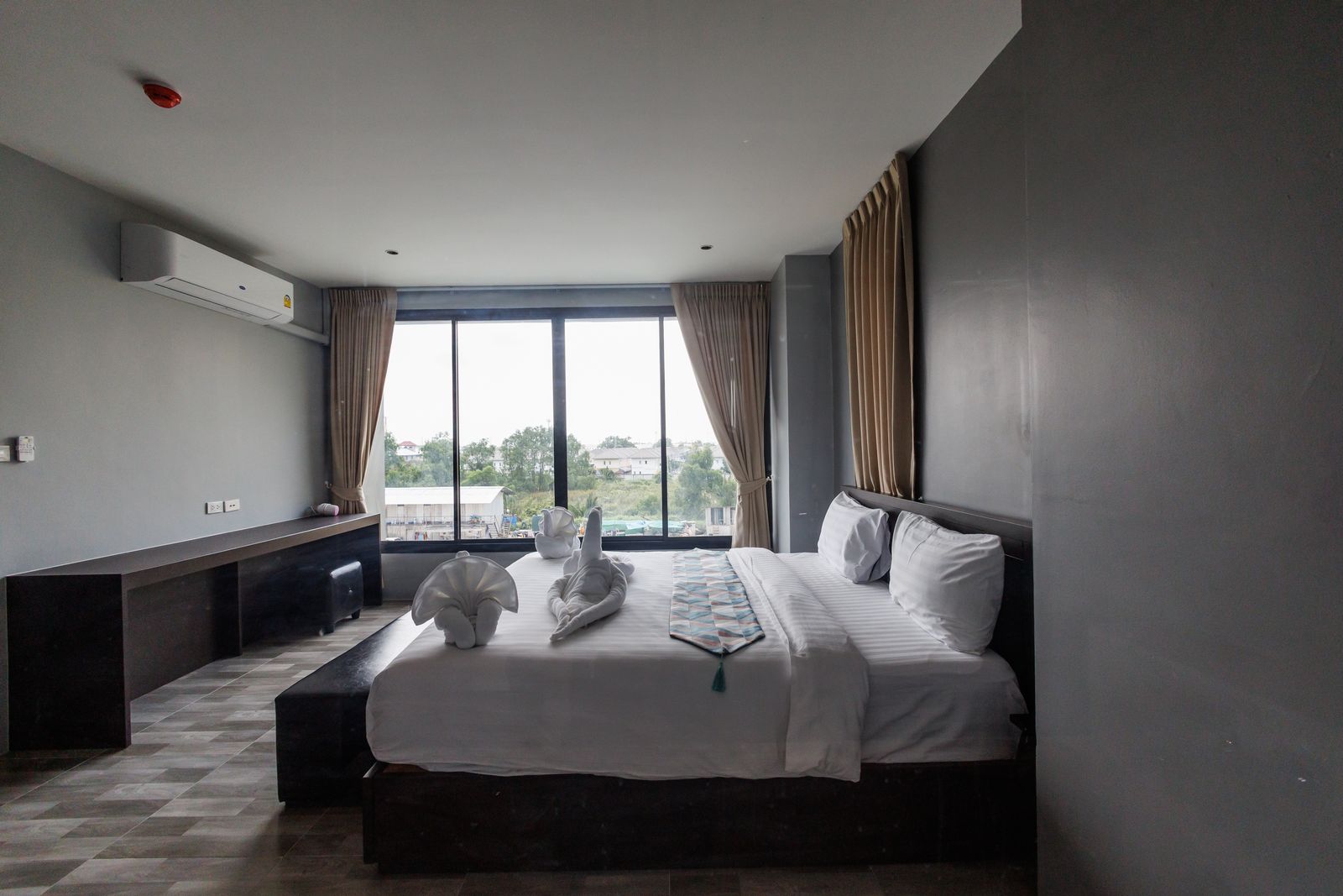 Bed with work desk and countryside view