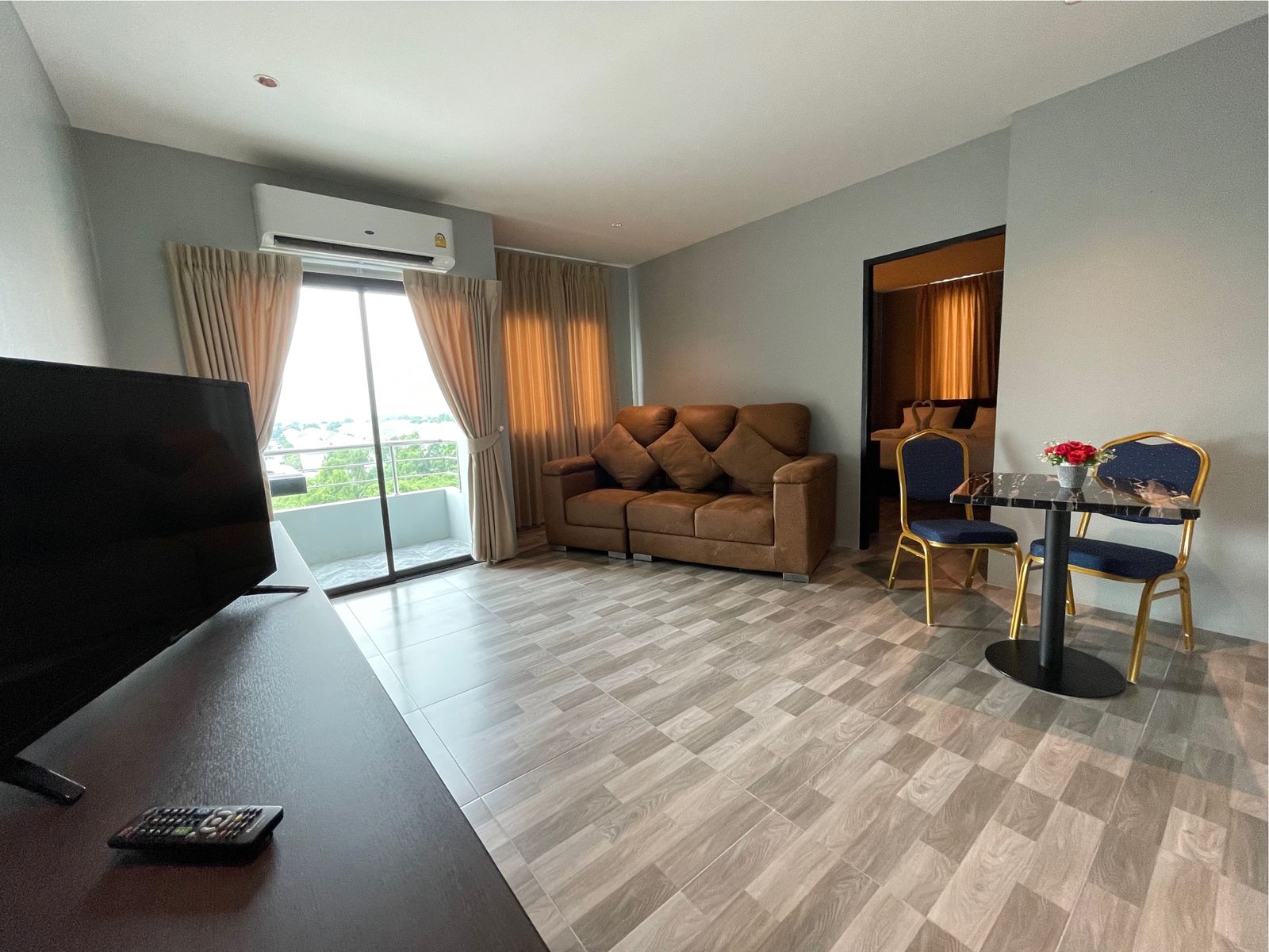 Living room with TV, sofa and dining table