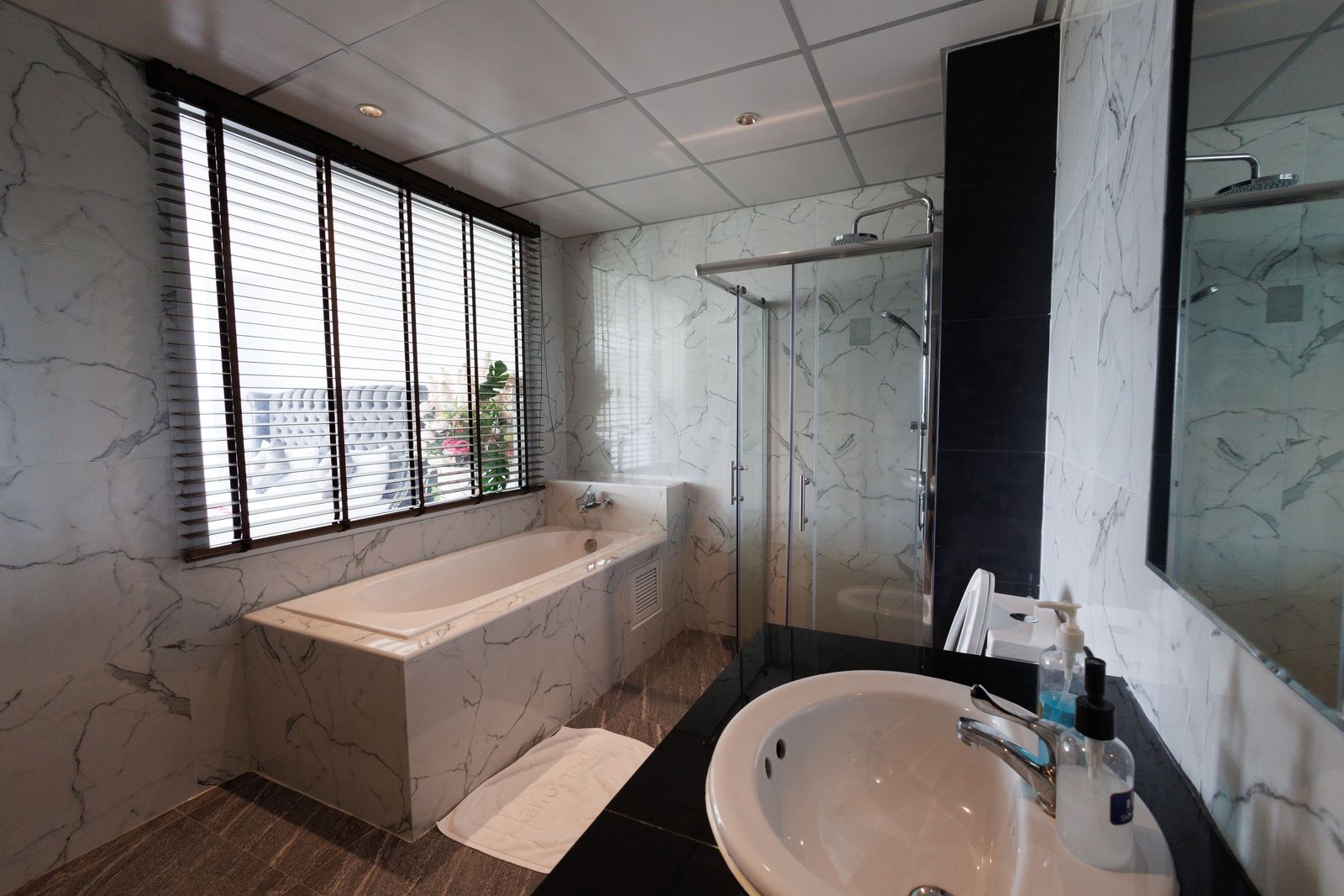 Marble bathroom with bathtub and vanity