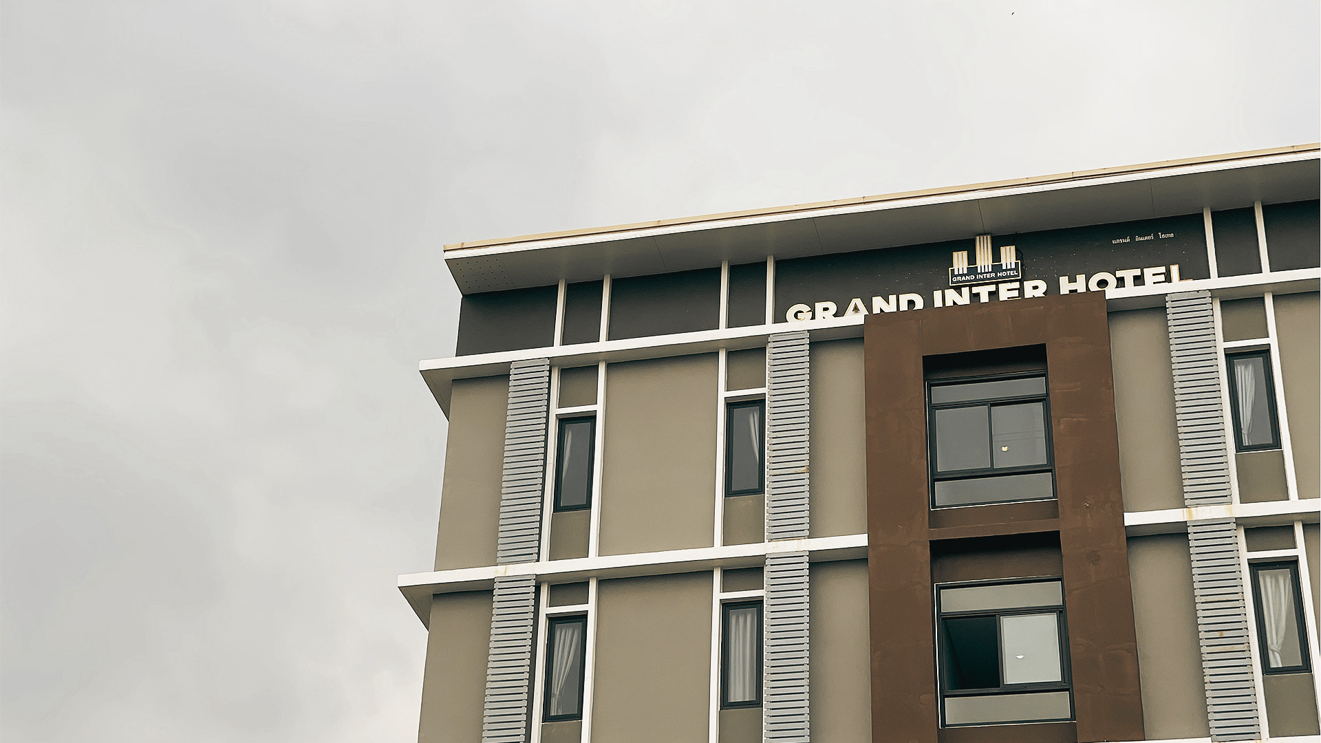 Grand Inter Hotel building with the hotel name on the rooftop sign